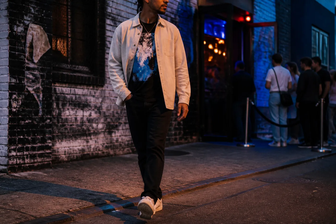 Millennial streetwear outfit outside a music venue at blue hour